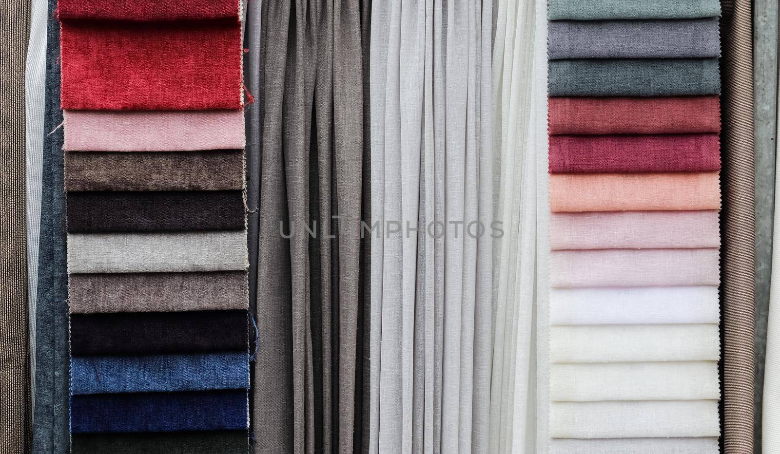 Detailed close up view on samples of cloth and fabrics in different colors found at a fabrics market.