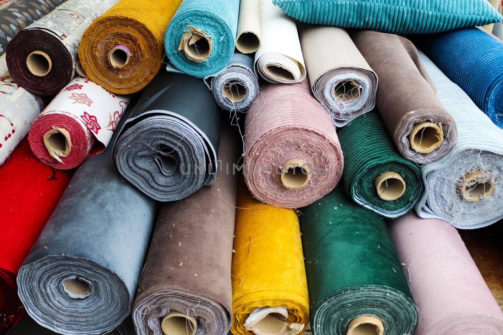 Detailed close up view on samples of cloth and fabrics in different colors found at a fabrics market.