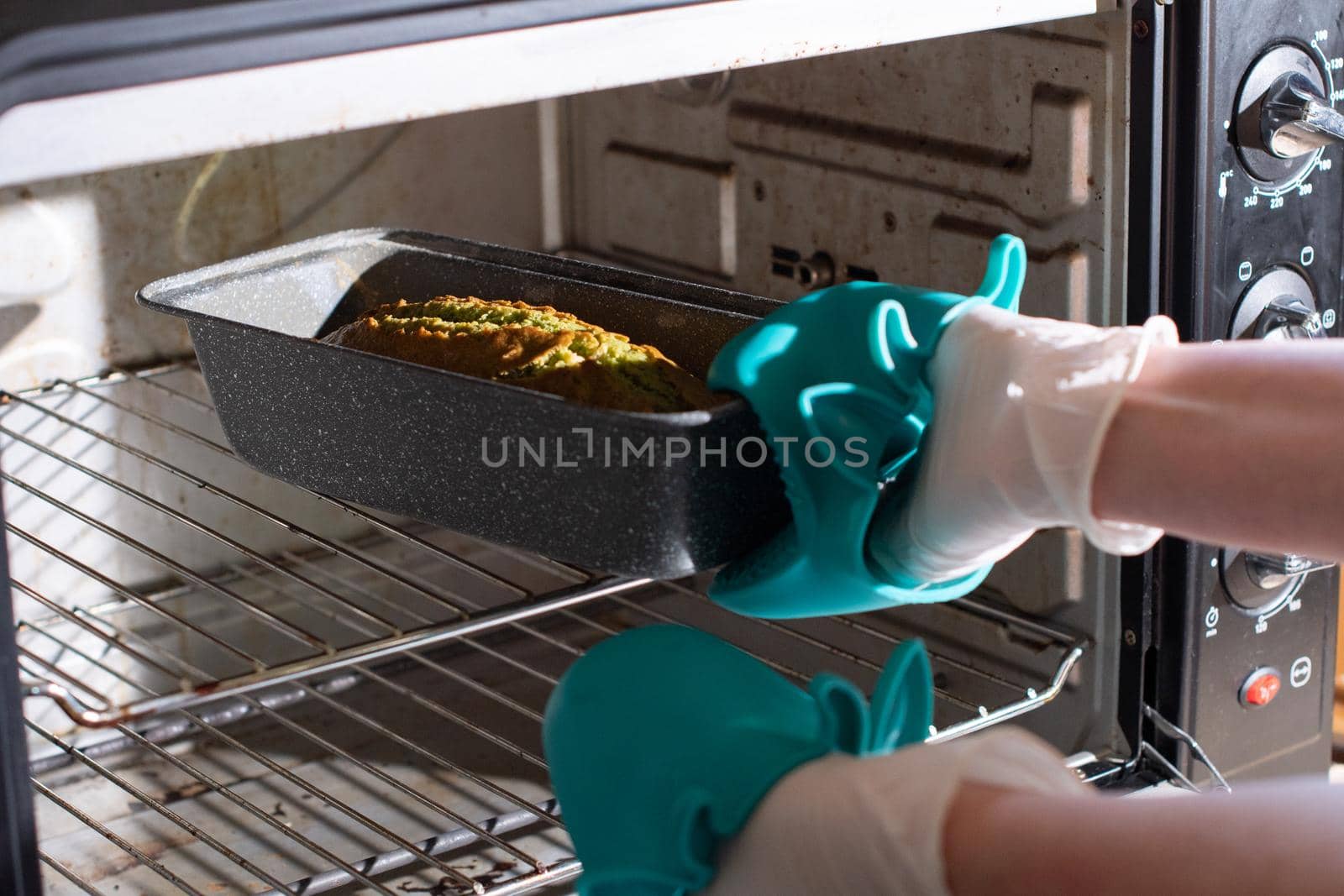 woman baked spinach muffin step by step,puts the form with the dough in the oven, High quality photo