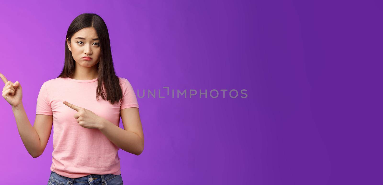 Moody upset whining girlfriend unhappy pointing left, sulking look miserable and distressed, express regret and disappointment, complain bad fortune, stand purple background displeased by Benzoix