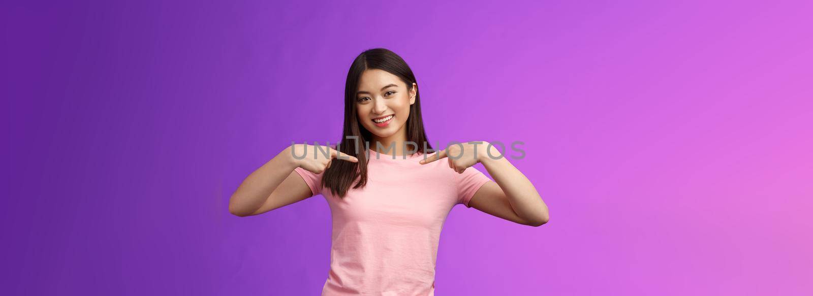 Active energized friendly tender asian stylish girl introduce herself, pointing chest proudly, smiling boastful, describe own achievements, bragging accomplishments, stand pleased purple background.