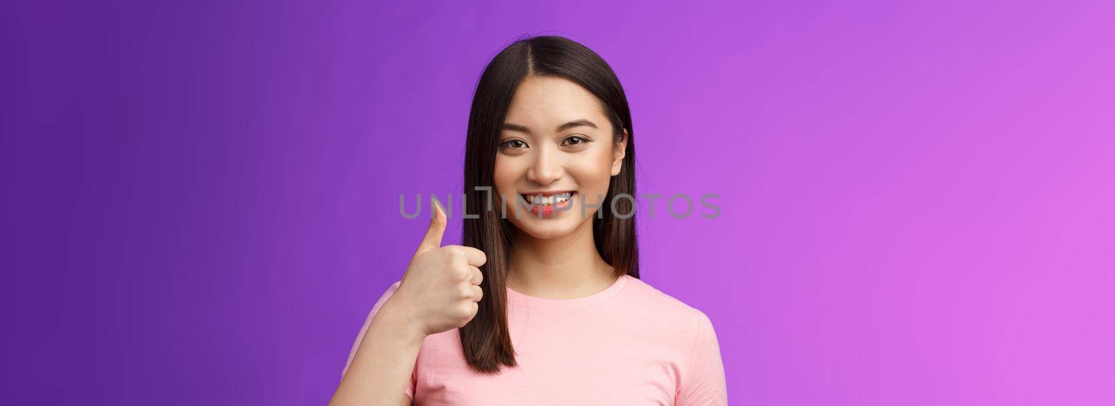 Friendly good-looking supportive asian female friend encourage you keep going, nice work, satisfied good job, smiling approval, show thumb-up gesture, grinning accepting perfect choice.