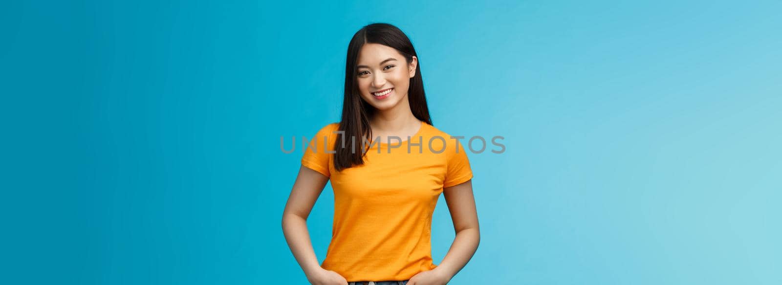 Carefree friendly asian girl with short dark hair tilt head lovely, smiling camera, hold hands jeans pockets, chatting casually, having pleasant normal conversation, discuss weekend picnic plans by Benzoix