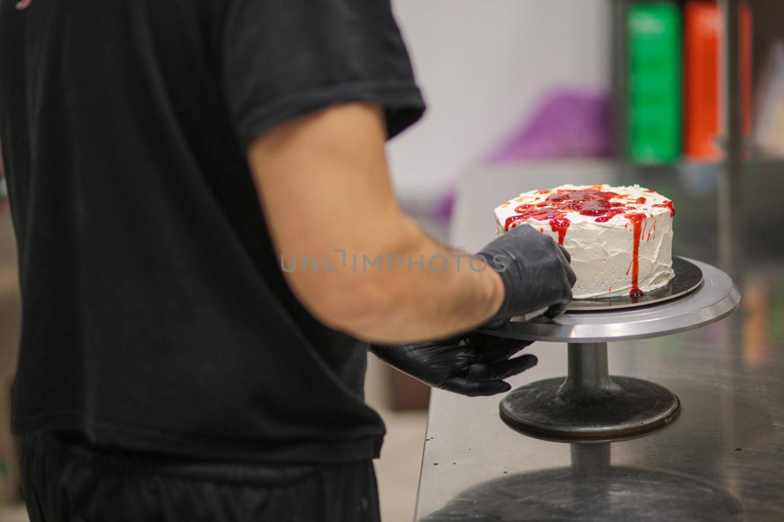 designer chef decorating white red bloody horror crime cake for halloween party by verbano