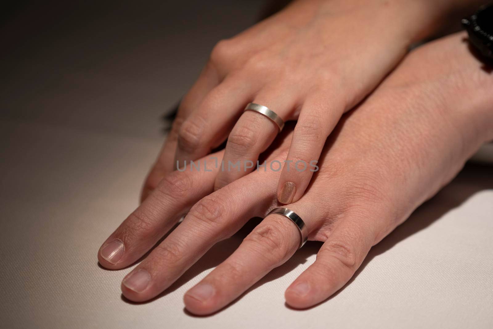 Just married couple holding hand with wedding rings. by papatonic