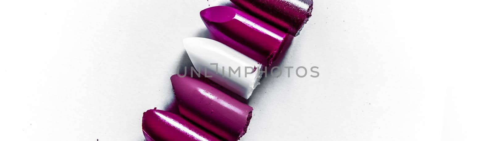 Beauty texture, cosmetic product and art of make-up concept - Cutted lipstick close-up isolated on white background