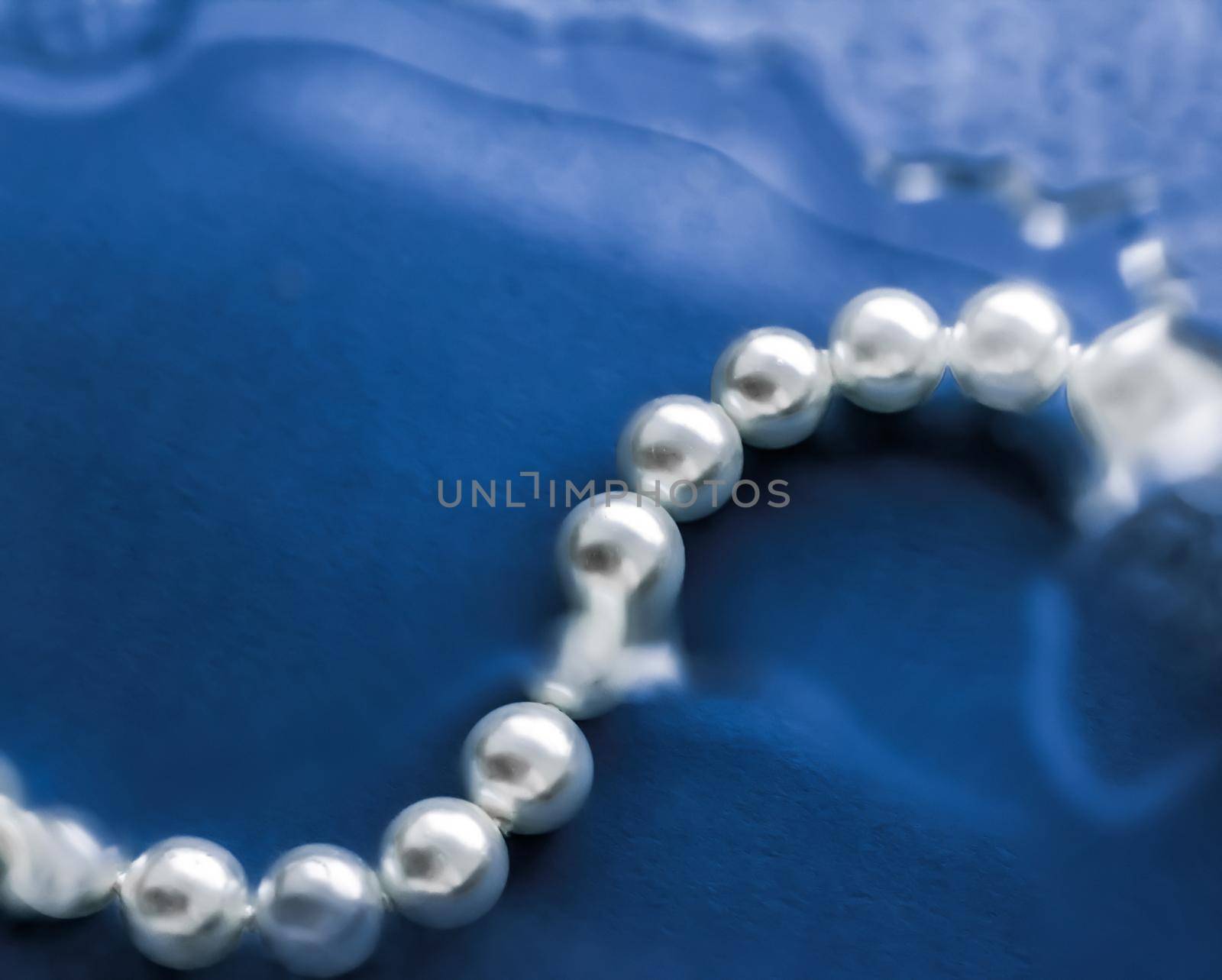 Jewelry, branding and gems concept - Coastal jewellery fashion, pearl necklace under blue water background, glamour style present and chic gift for luxury jewelery brand, holiday banner design