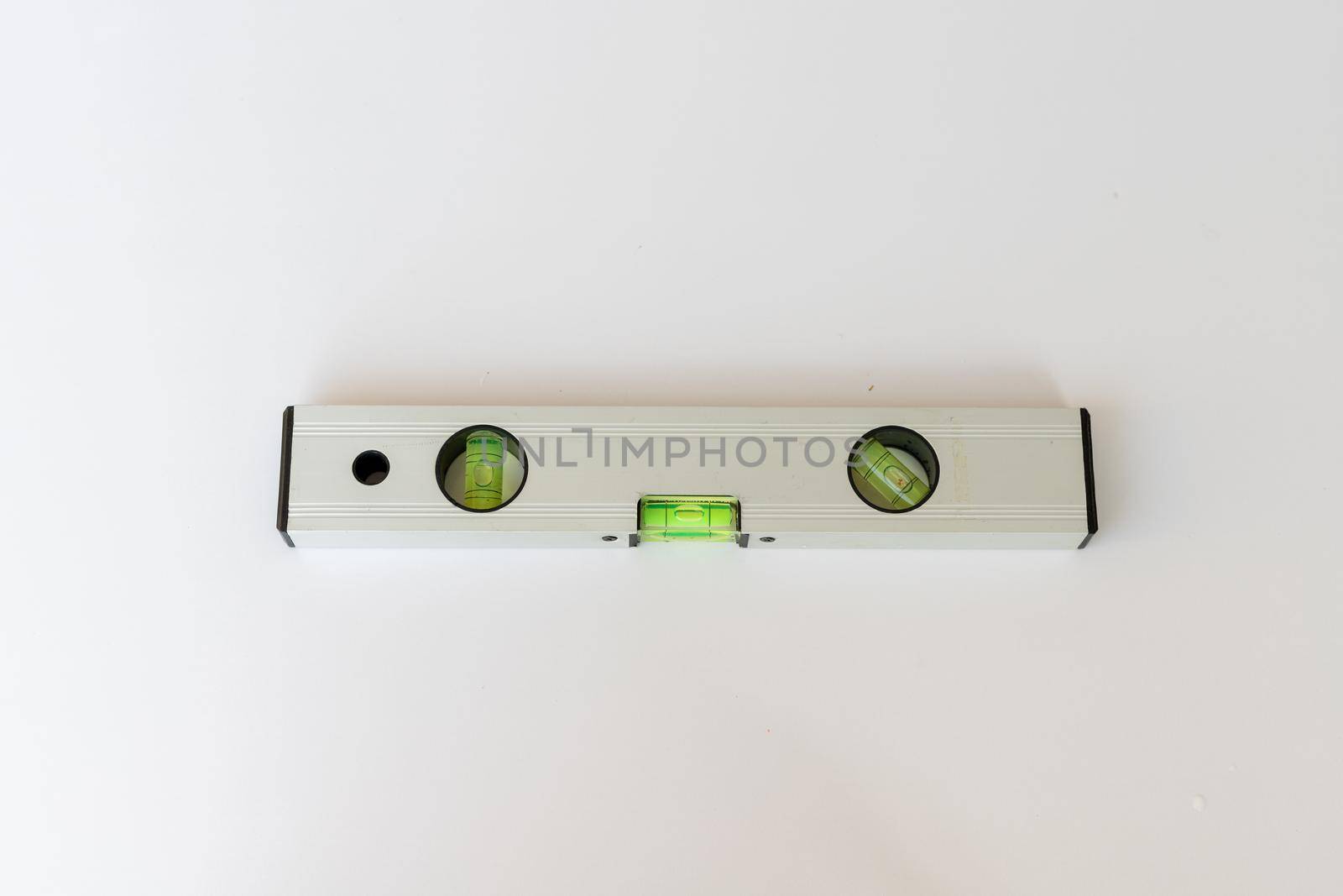 spirit leveling tool laying on a white isolated background
