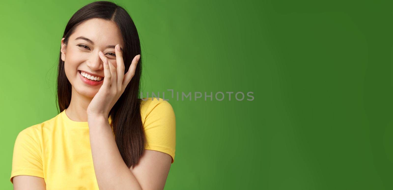 Waist-up sincere happy cheerful tender feminine asian woman brunette, laughing carefree smiling, enjoy entertaining company, giggle, touch face shy blushing cute compliments, gree background.