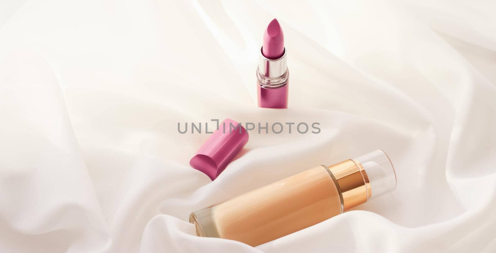 Cosmetic branding, glamour and skincare concept - Beige tonal cream bottle make-up fluid foundation base and pink lipstick on silk background, cosmetics products as luxury beauty brand holiday design