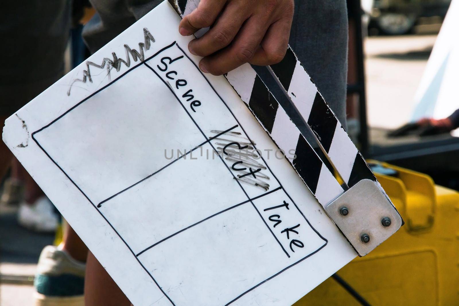 close up image of film production crew holding Film Slate on set