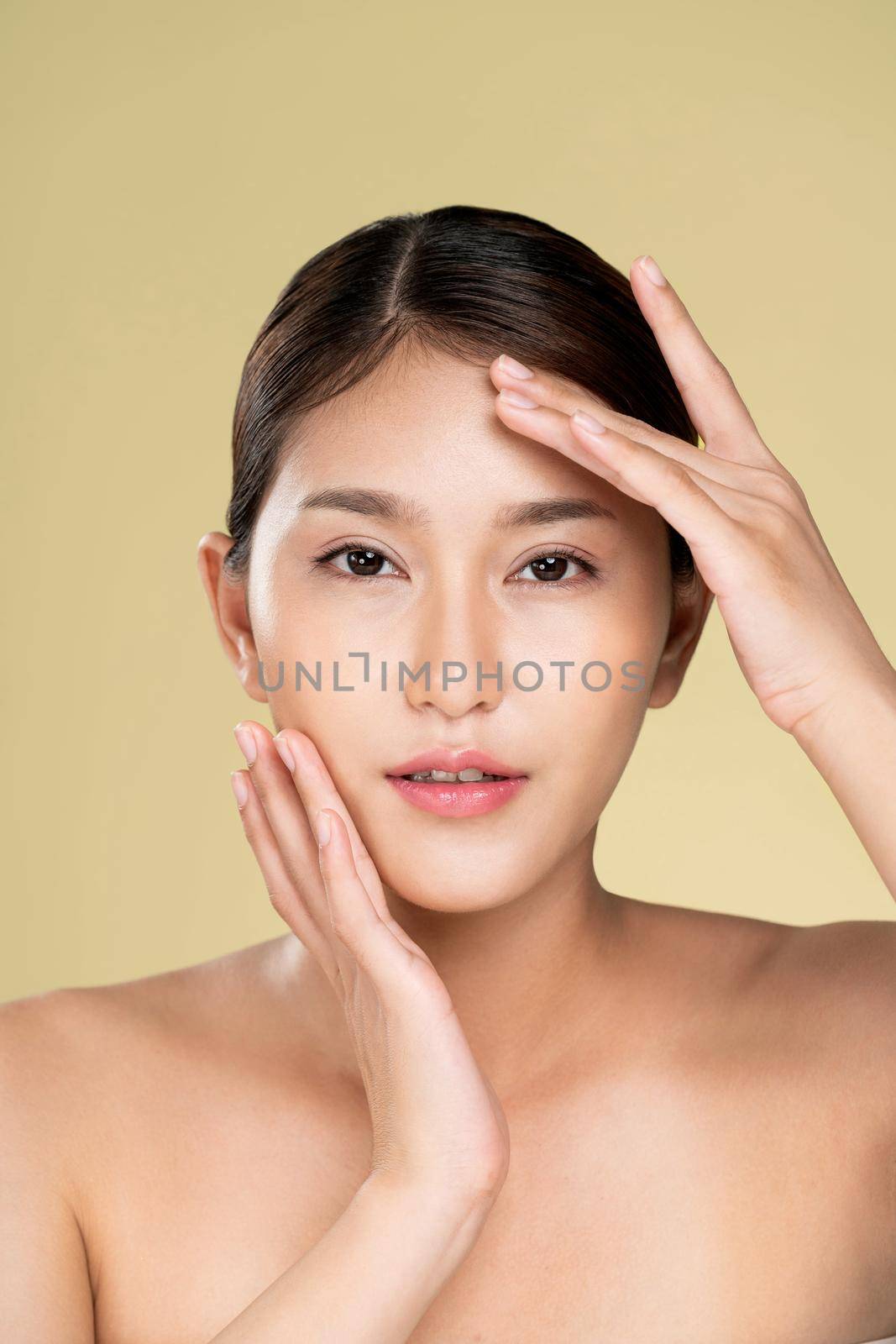 Closeup ardent young woman posing beauty gesture with clean fresh skin. by biancoblue