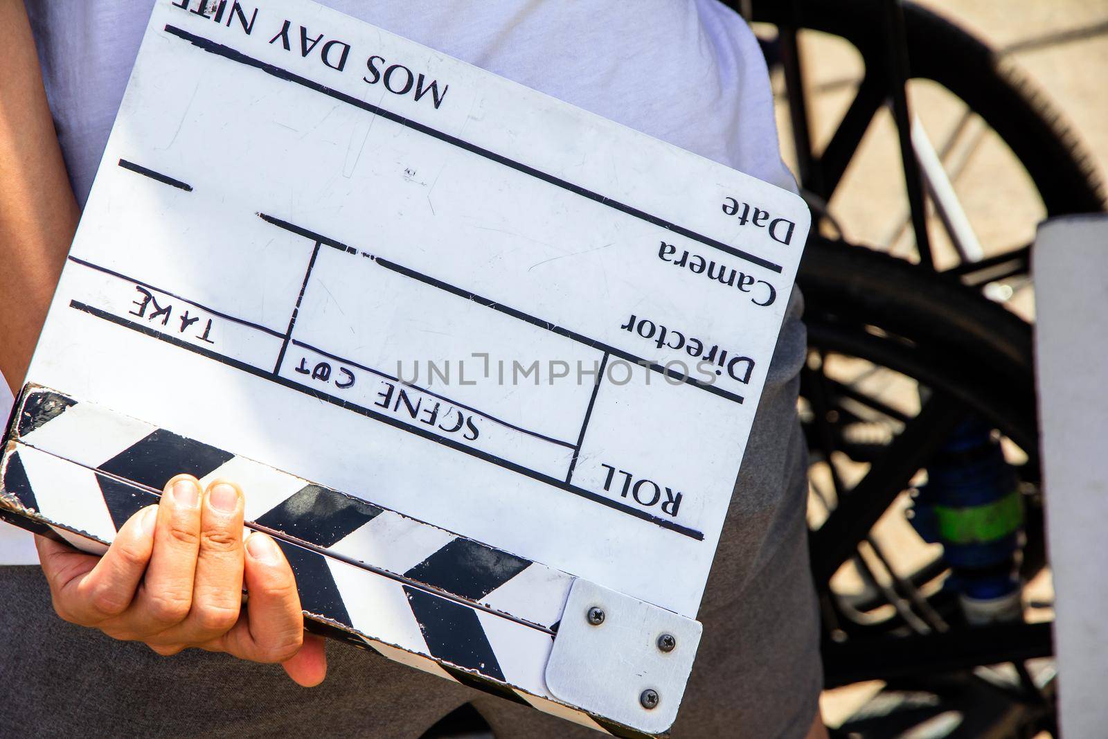 close up image of film production crew holding Film Slate on set