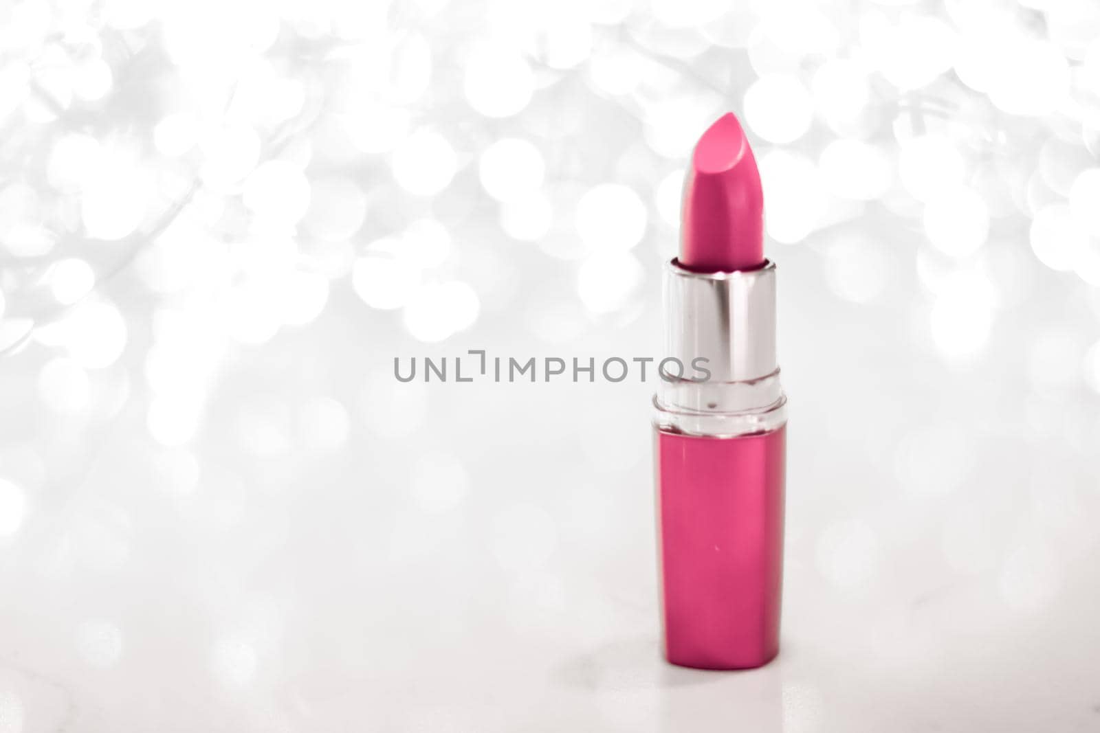 Cosmetic branding, sale and glamour concept - Pink lipstick on silver Christmas, New Years and Valentines Day holiday glitter background, make-up and cosmetics product for luxury beauty brand