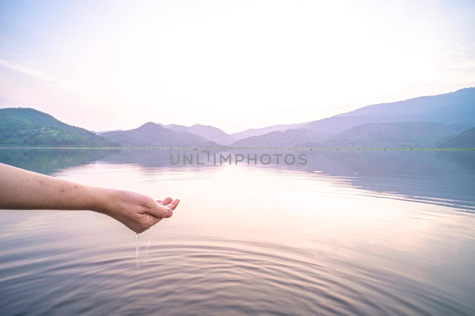 Woman taking clear water by hands