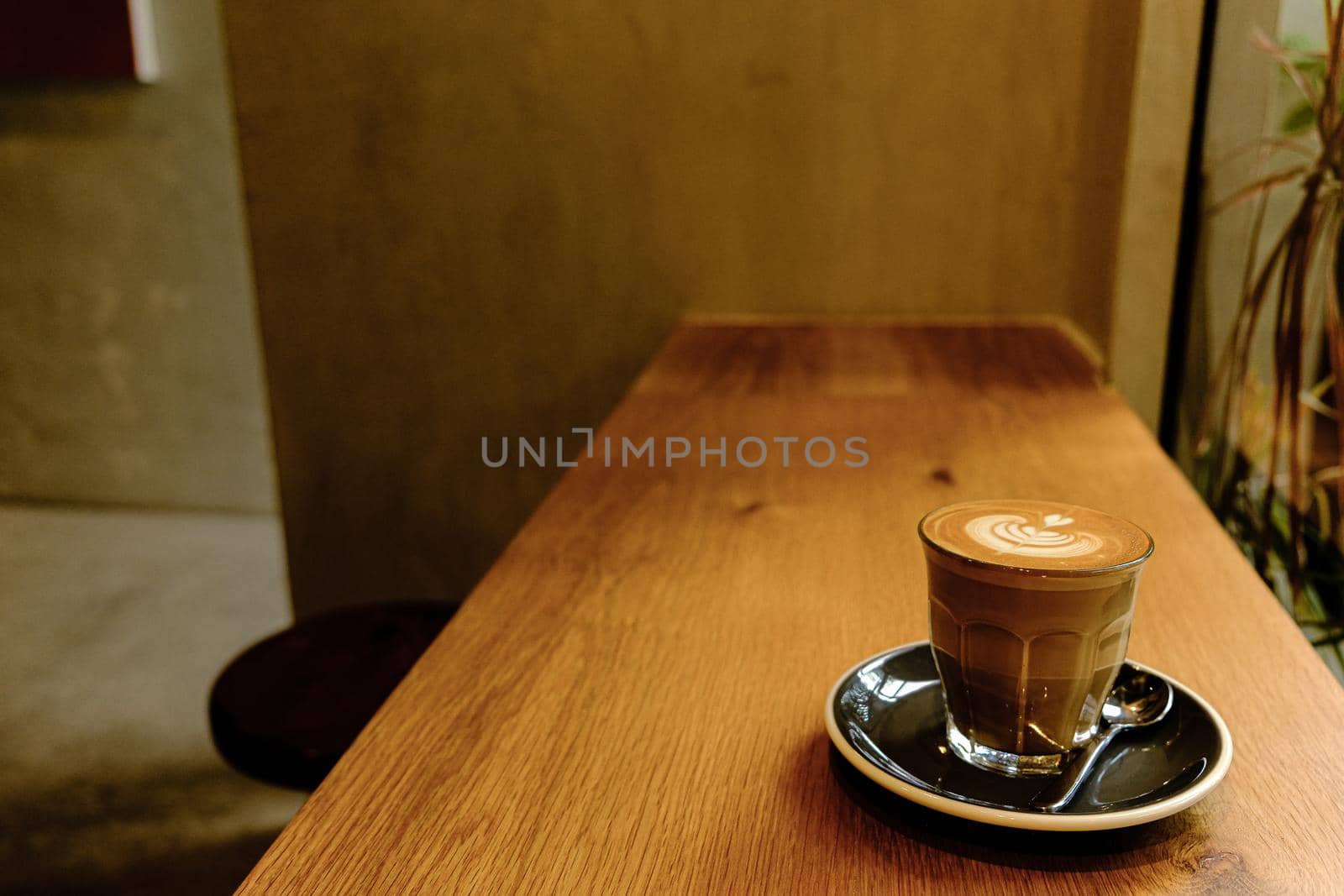 A cup of coffee latte top view with leaf shape foam