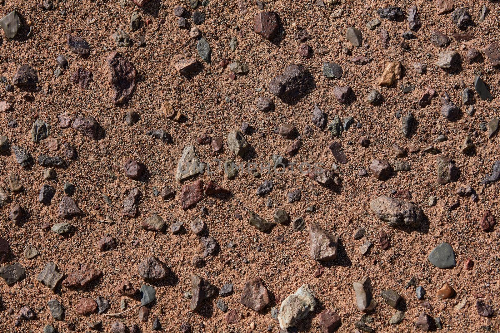 Black Gobi. Stony desert, black stones on the sand. Abstract natural background.
