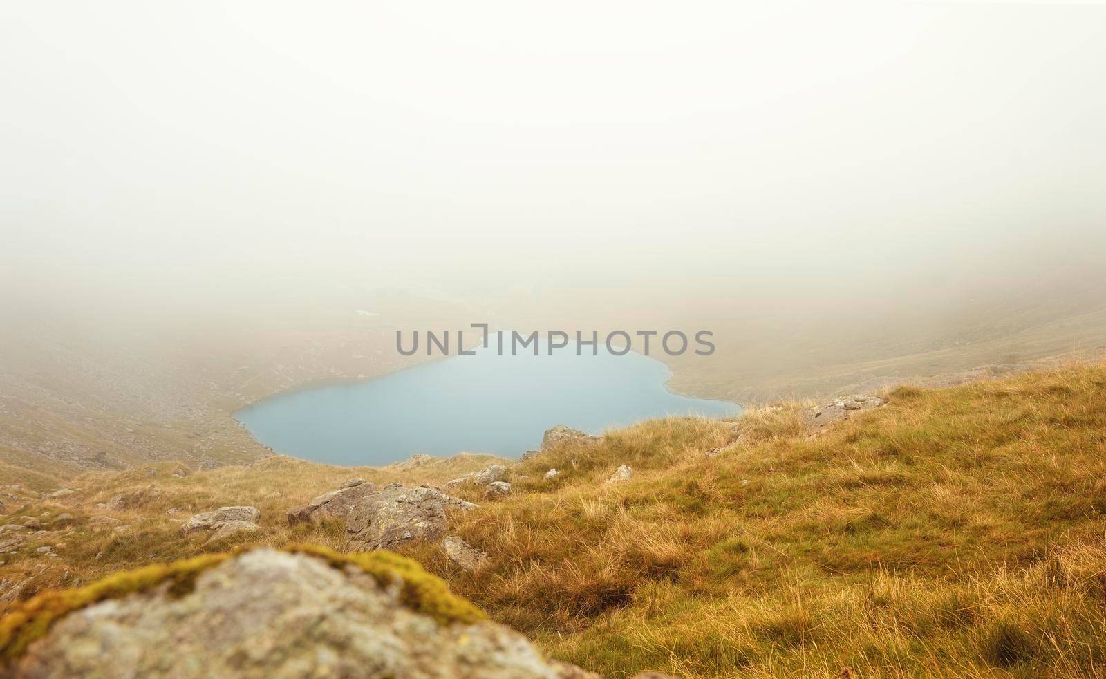 Amazing view in the national park Lake District in England on a foggy day in Autumn by Iryna_Melnyk