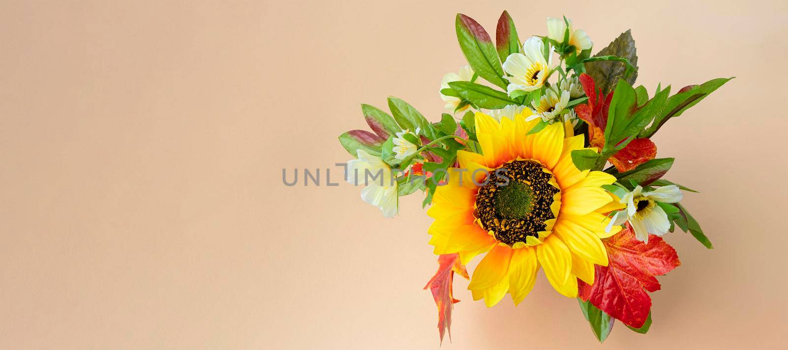 banner with fall bouquet on light background with place for text. sunflower and autumn leaves. copy space