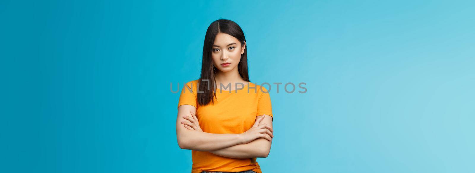 Serious-looking confident and arrogant asian woman cross hands chest powerful ignorant pose, look indifferent strict bored face, stand blue background unimpressed, demand answers by Benzoix