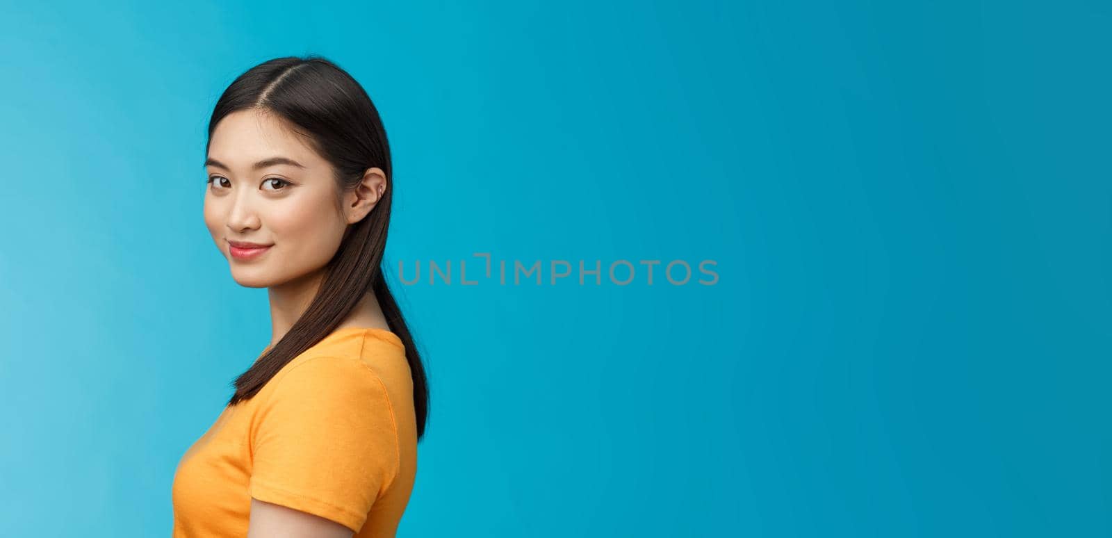 Close-up tender feminine stylish young female turn camera stand profile, look camera amused joyful, satisfied getting rid acne, taking care facial blemish, stand blue background delighted by Benzoix