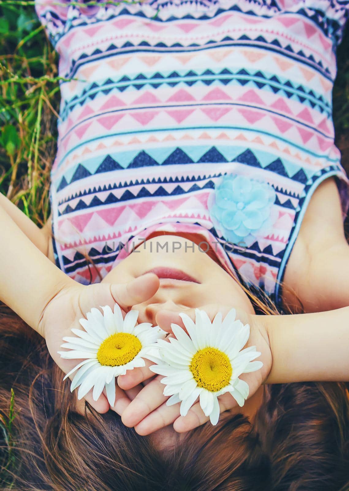 Girl with chamomile. Selective focus. nature flowers. Child.