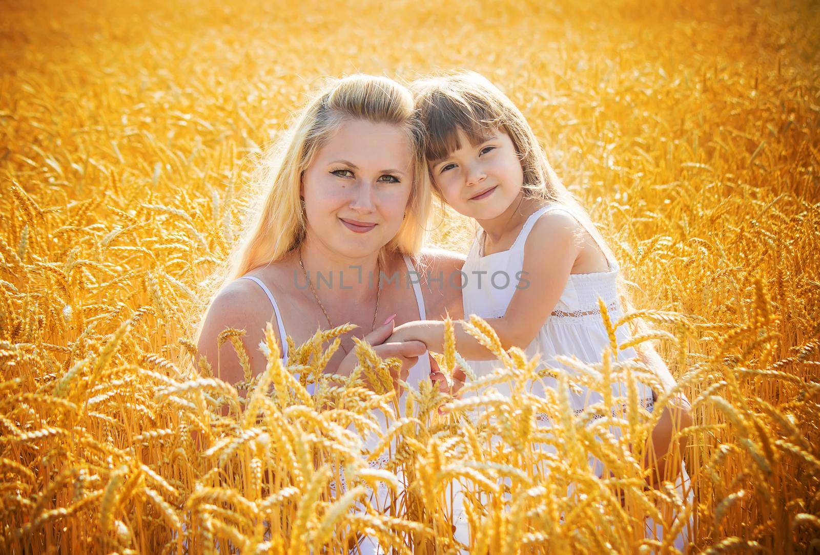 mother and daughter in a wheat field. selective focus. Nature.