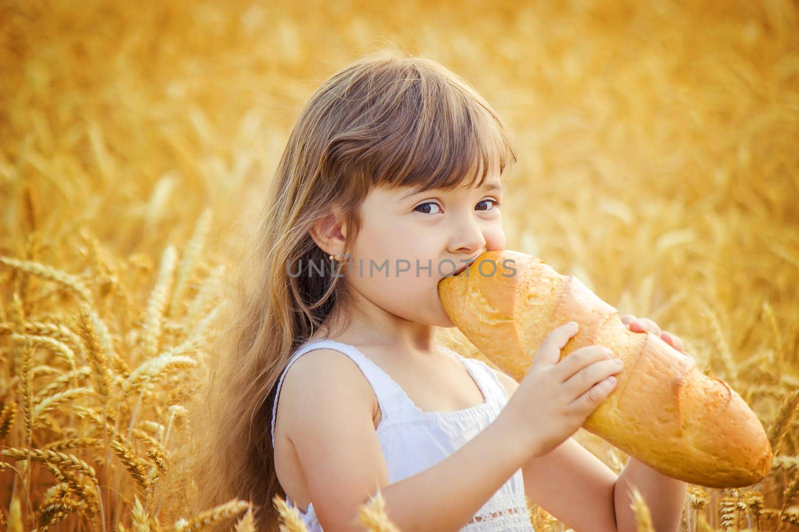 Child and bread. selective focus. food and drink. by yanadjana