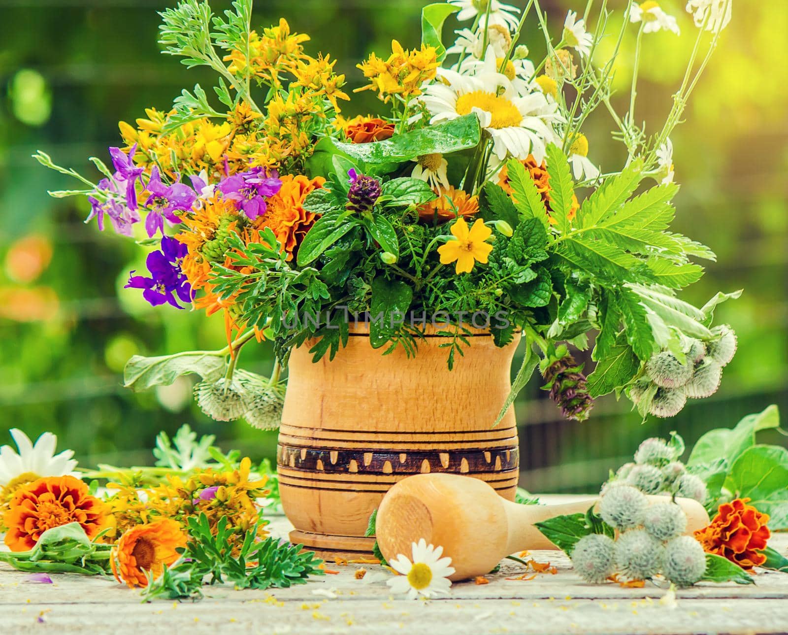 Herbs in a mortar. Medicinal plants. Selective focus. by yanadjana