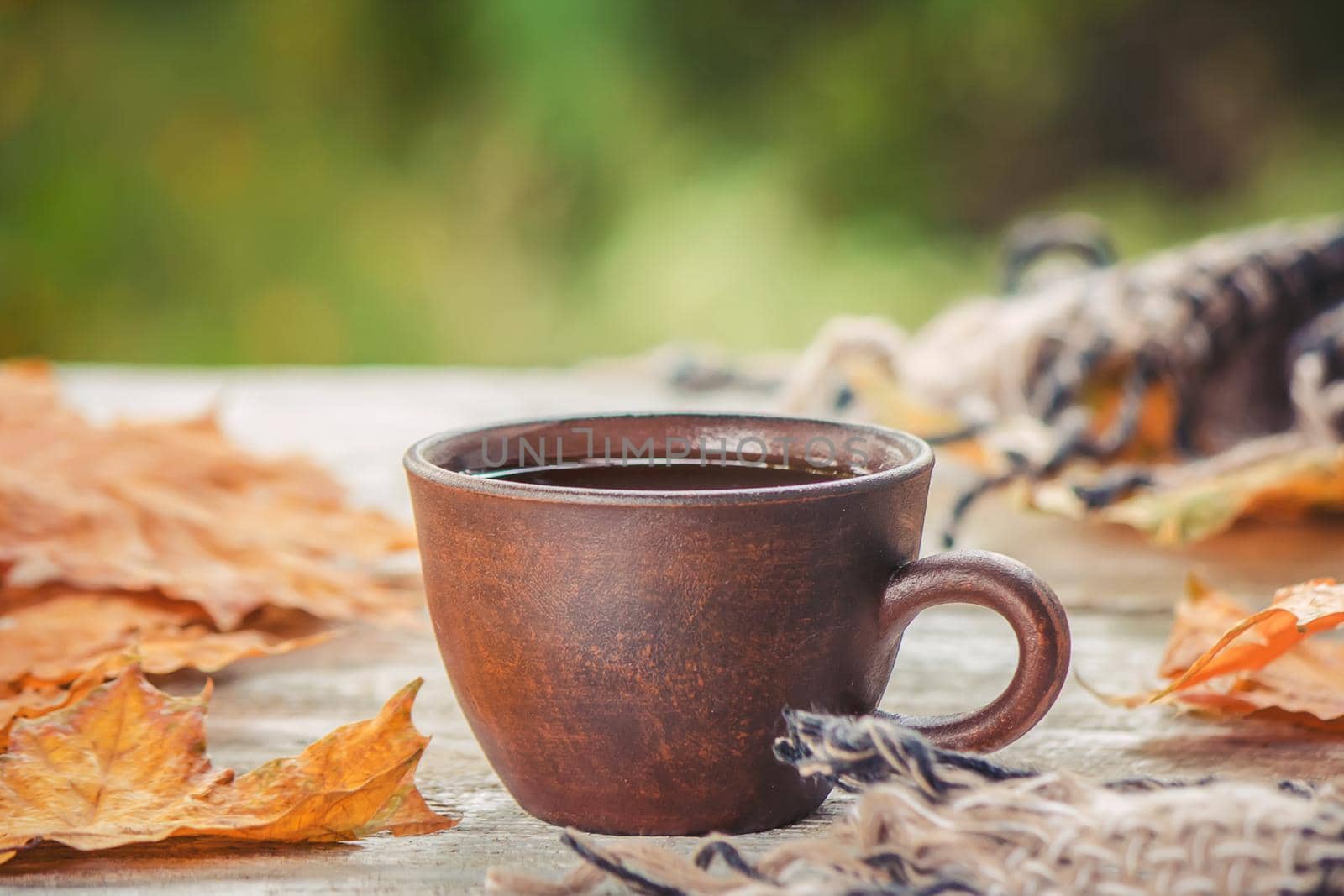 A cup of tea and a cozy autumn background. Selective focus. food.