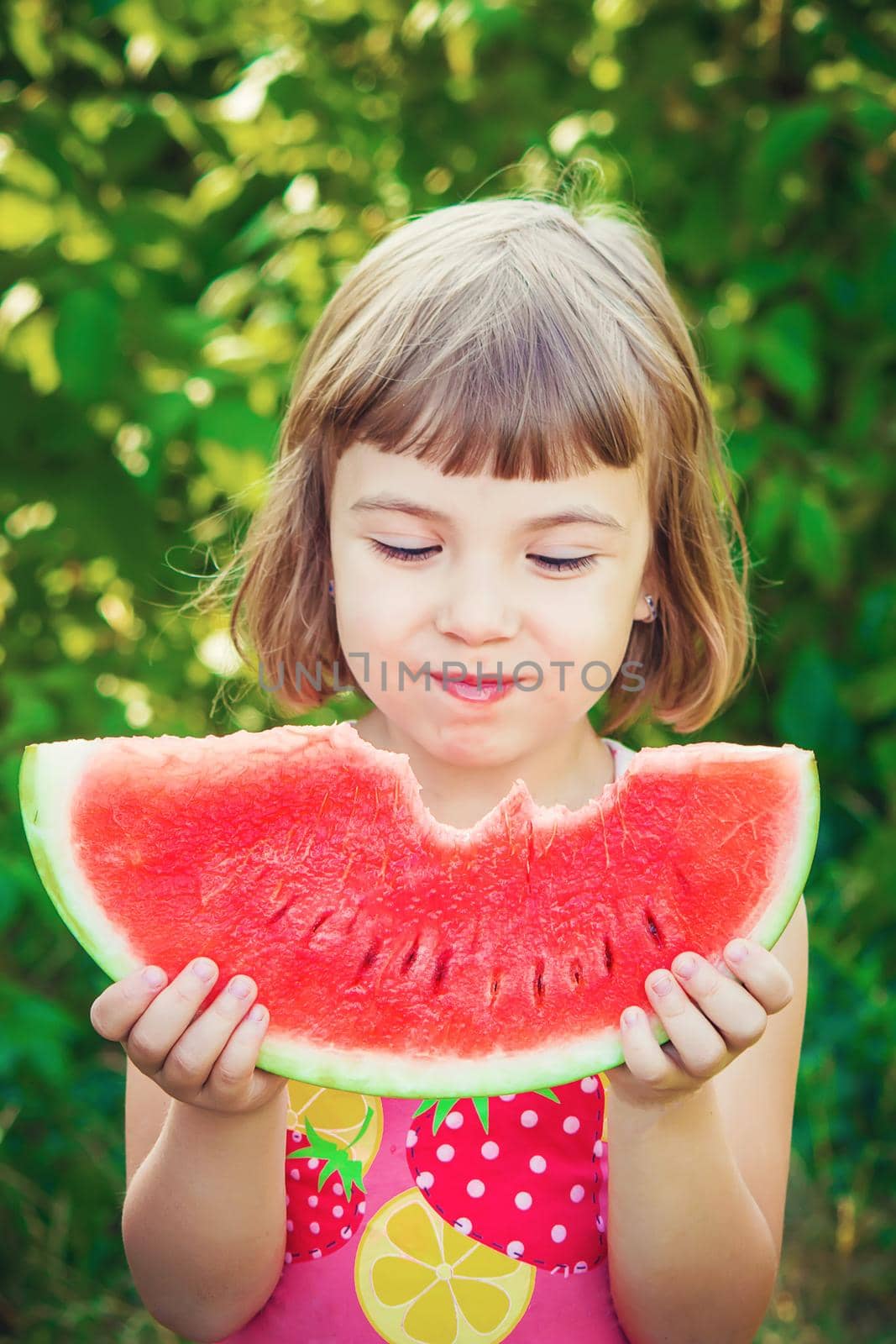 A child eats watermelon. Selective focus. Food. by yanadjana