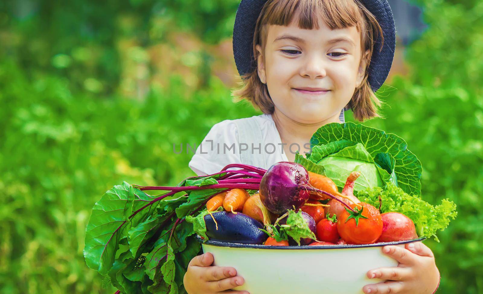 Child and vegetables on the farm. Selective focus. nature.