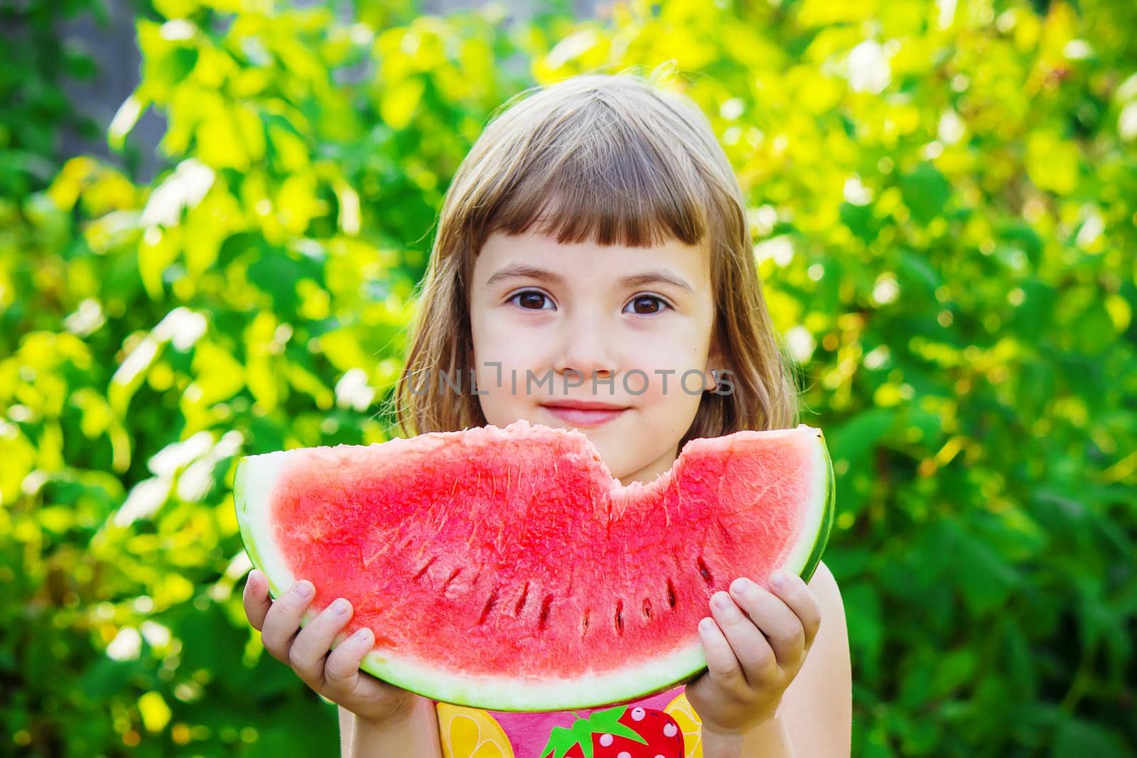 A child eats watermelon. Selective focus. Food nature.