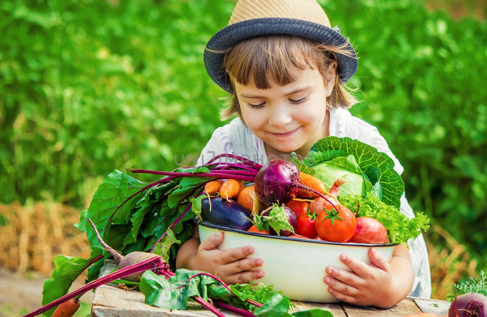 Child and vegetables on the farm. Selective focus. nature.