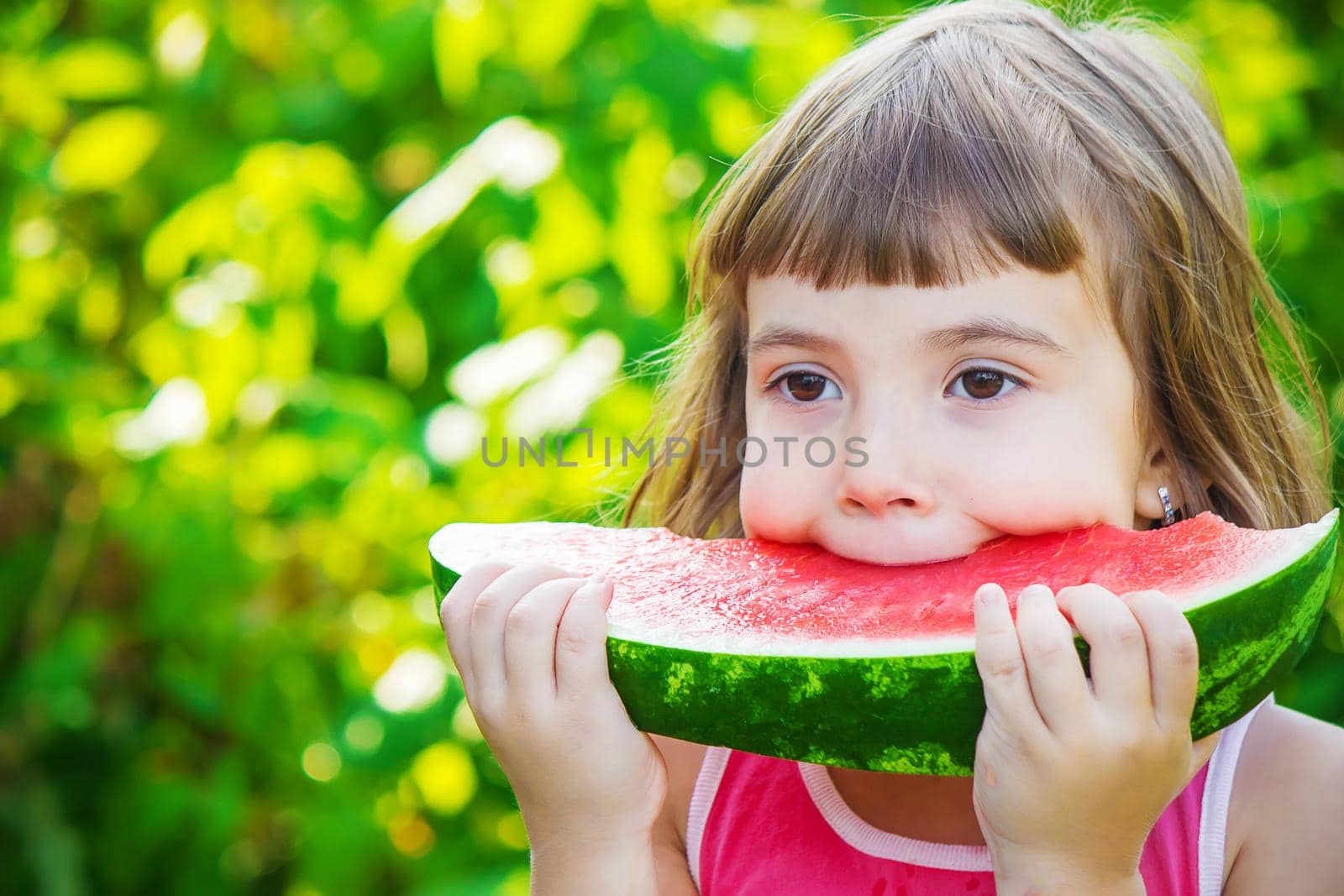 A child eats watermelon. Selective focus. Food nature.