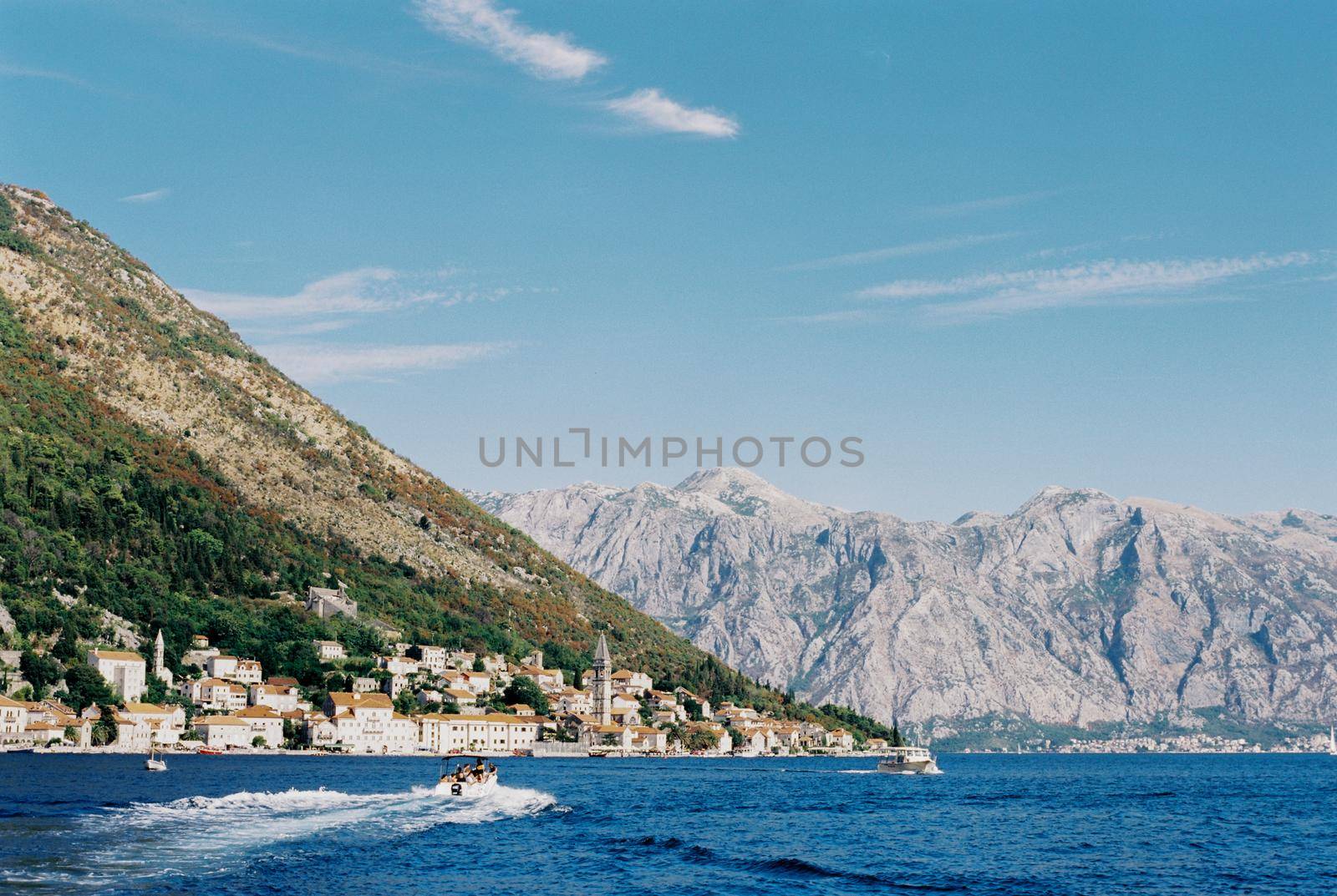 Motorboat sails to the coast of Perast. Montenegro. High quality photo