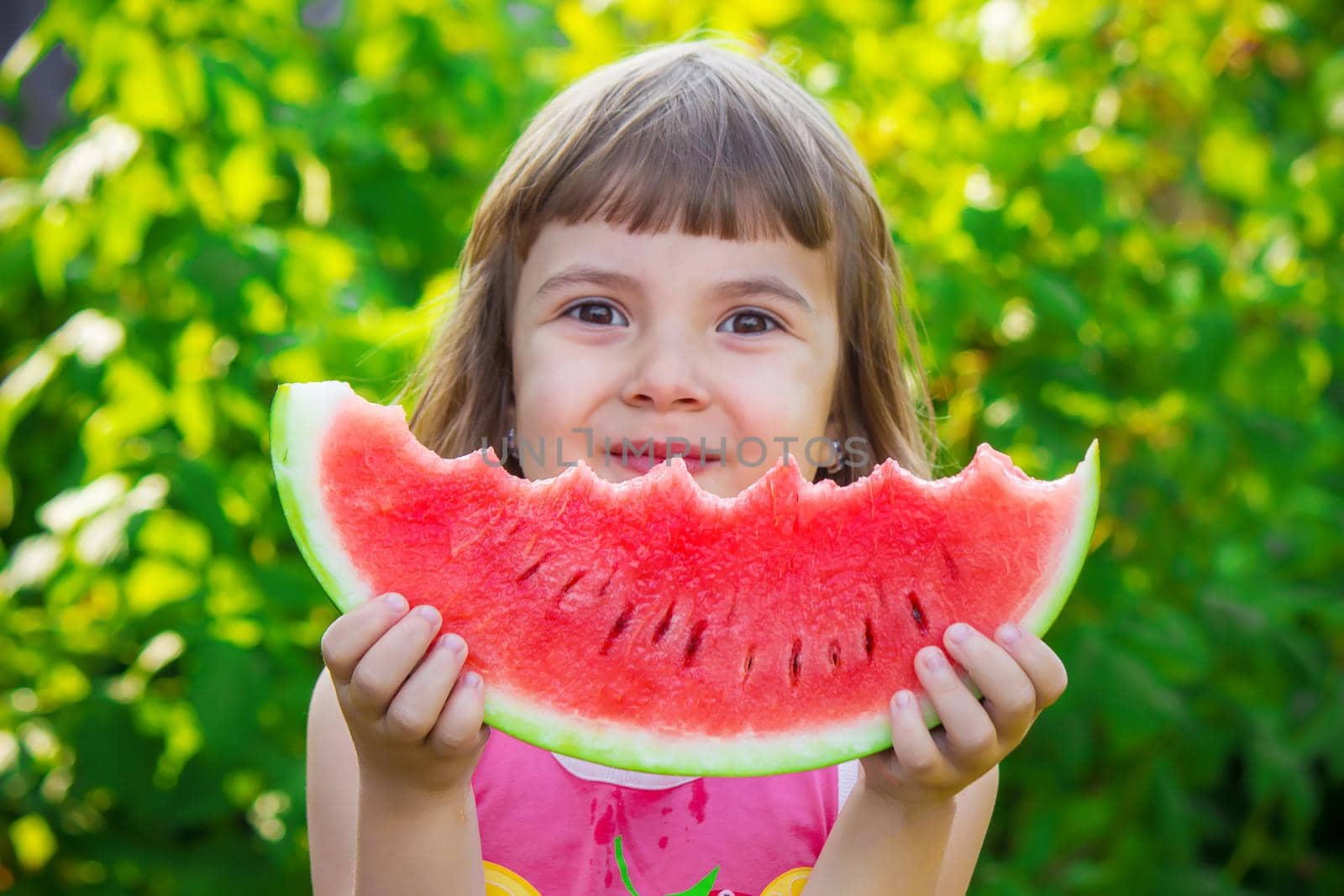 A child eats watermelon. Selective focus. Food nature.