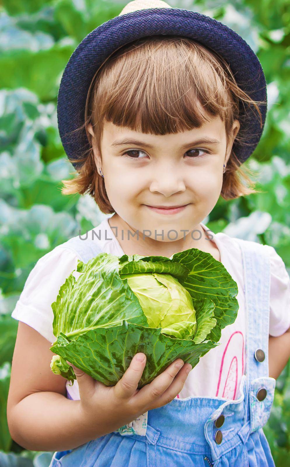 Child and vegetables on the farm. Selective focus. nature.