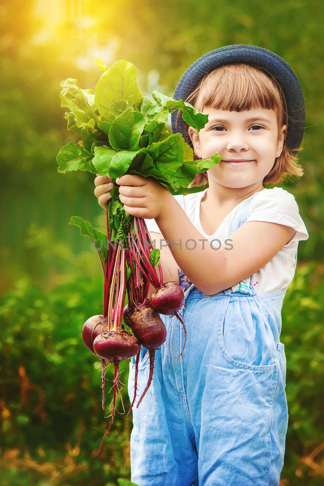 Child and vegetables on the farm. Selective focus. by yanadjana