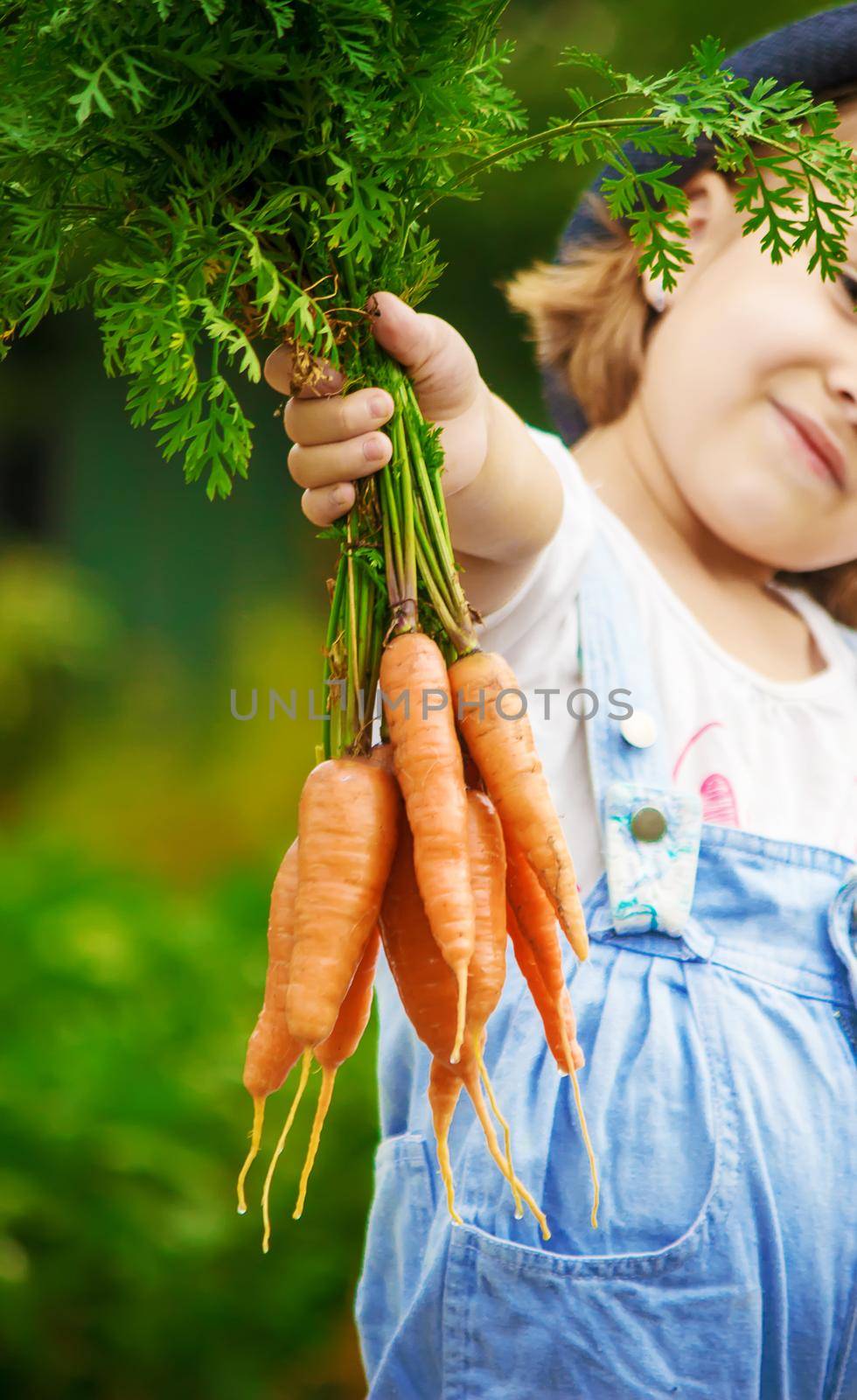 Child and vegetables on the farm. Selective focus. by yanadjana