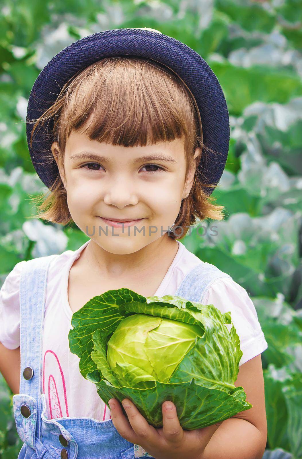 Child and vegetables on the farm. Selective focus. nature.