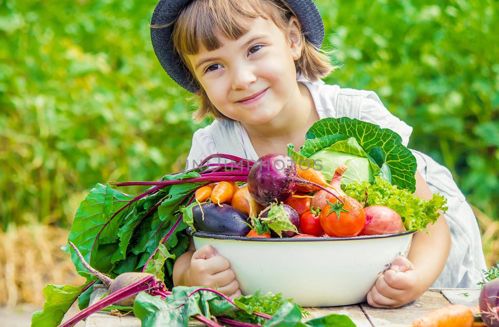 Child and vegetables on the farm. Selective focus. nature.