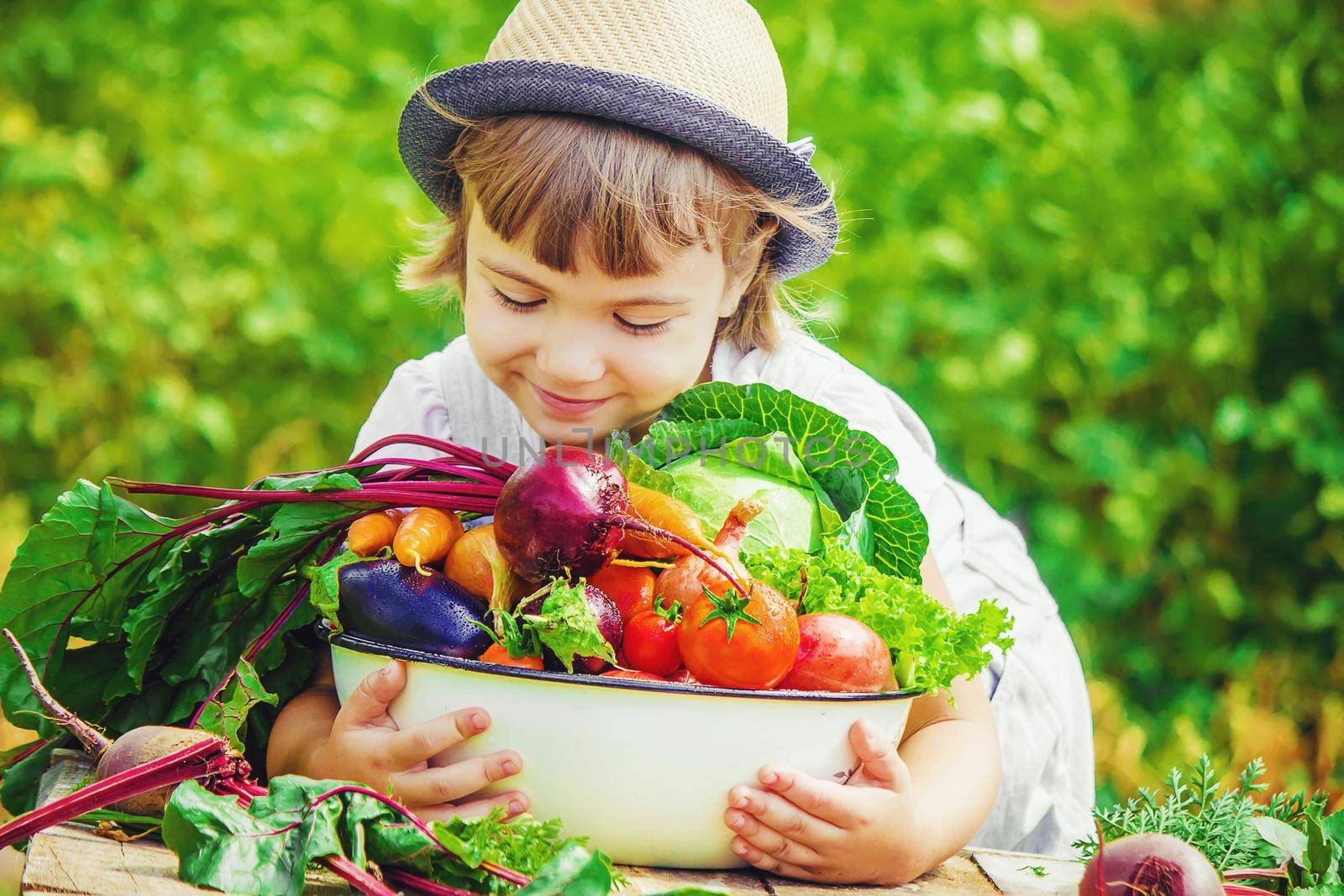 Child and vegetables on the farm. Selective focus. nature.