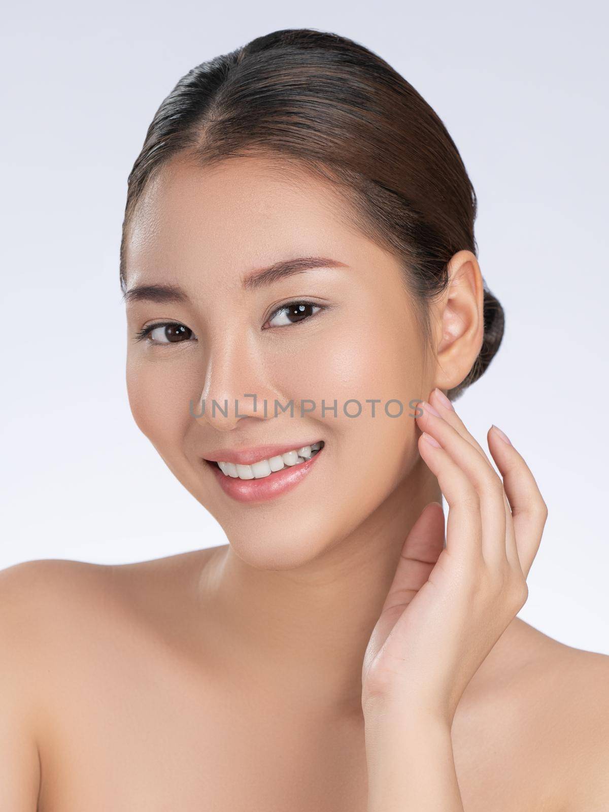 Portrait of gorgeous young girl posing beauty gesture with clean fresh skin. by biancoblue