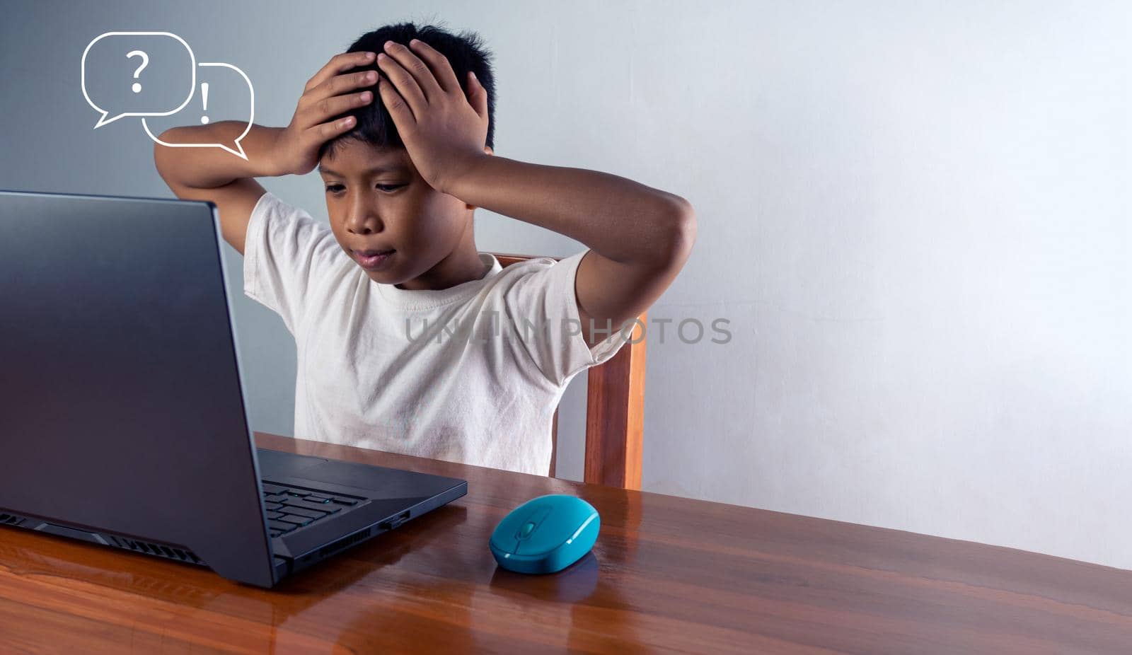 Education concept image. Creative idea and innovation. the boy sat staring at the computer and touched his temple. represents the inability to think by Unimages2527
