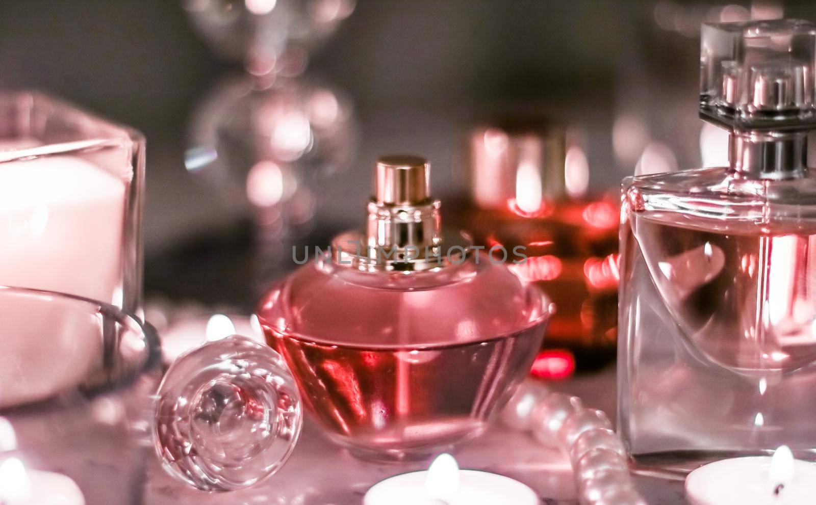 Perfumery, cosmetics branding and luxe concept - Perfume bottle and vintage fragrance on glamour vanity table at night, pearls jewellery and eau de parfum as holiday gift, luxury beauty brand present