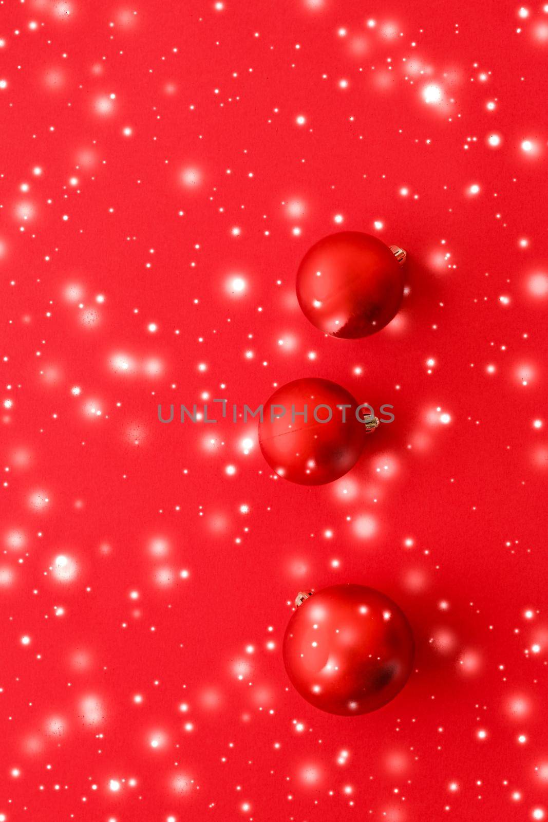 Gift decor, New Years Eve and happy celebration concept - Christmas baubles on red background with snow glitter, luxury winter holiday card