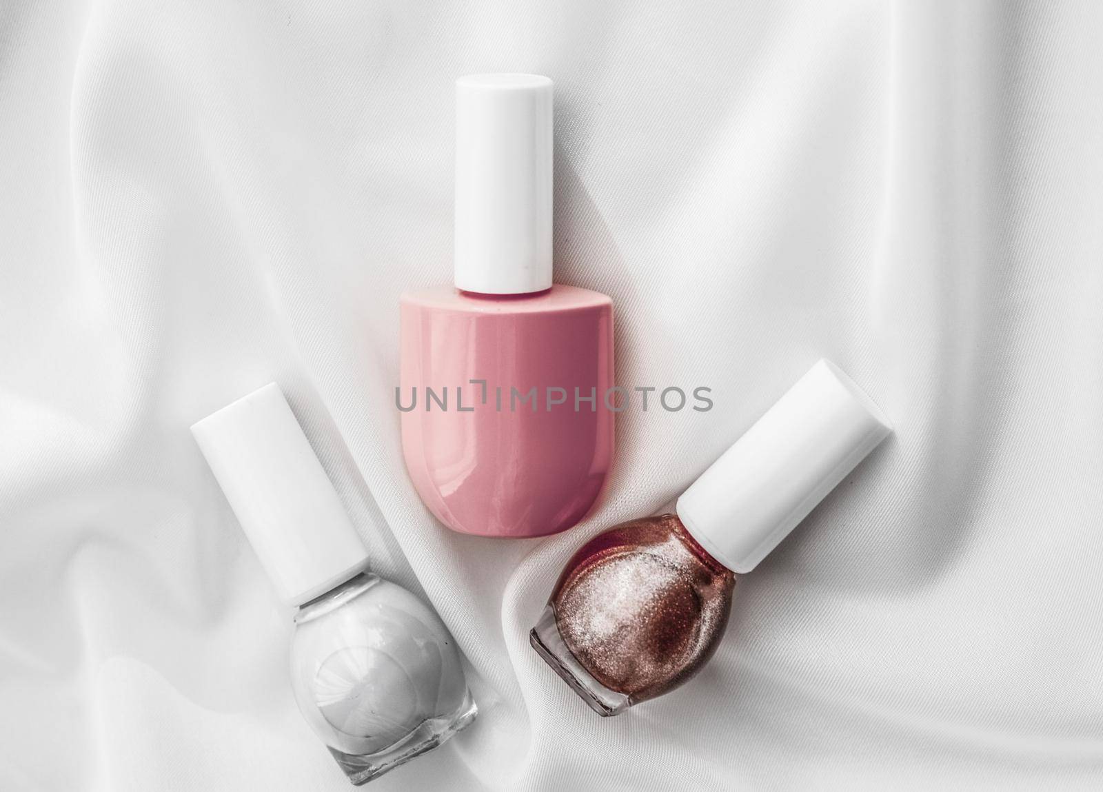 Cosmetic branding, salon and glamour concept - Nail polish bottles on silk background, french manicure products and nailpolish make-up cosmetics for luxury beauty brand and holiday flatlay art design