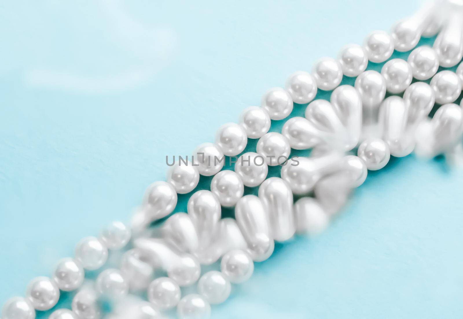 Jewelry, branding and gems concept - Coastal jewellery fashion, pearl necklace under blue water background, glamour style present and chic gift for luxury jewelery brand, holiday banner design