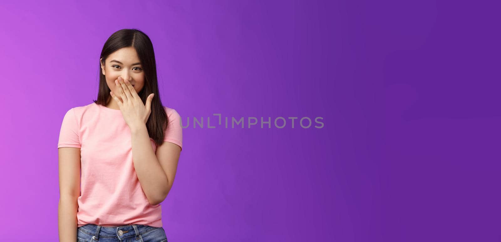 Timid cute stylish modern asian woman giggling, gossiping, cover smiling lips, laughing out loud joyfully, look camera entertained, fool around, spread funny rumors, stand purple background by Benzoix